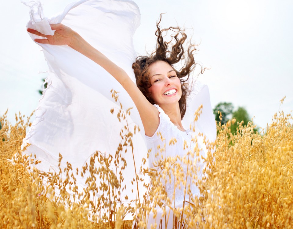 Beautiful Happy Girl on the Wheat Field